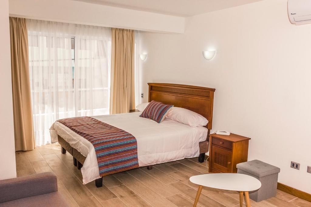 Apart Hotel Viscachani客房内的一张或多张床位
