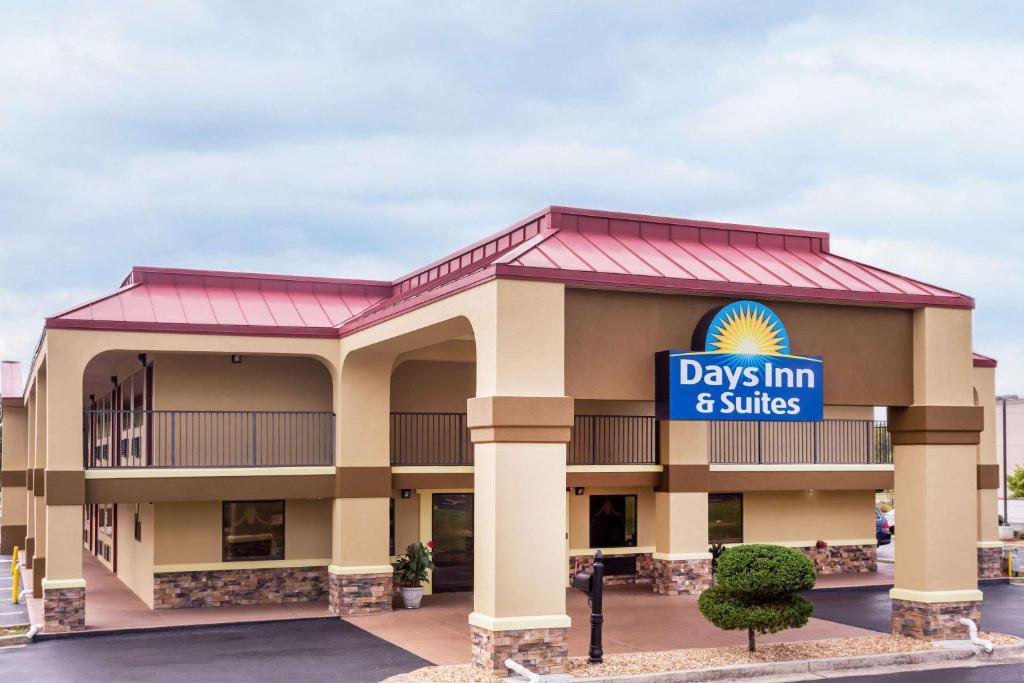 华纳罗宾斯Days Inn & Suites by Wyndham Warner Robins Near Robins AFB的大楼前的几天套房标志