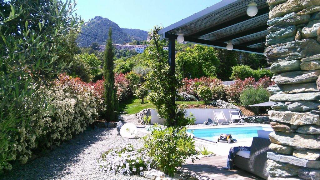Valle-di-CampoloroA Sulana Chambre d'hôtes的后院设有游泳池和石头建筑