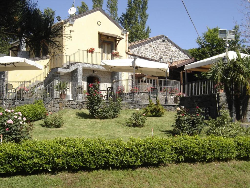 圣阿尔菲奥Ai Vecchi Crateri的一座房子,里面设有一座带灌木丛和遮阳伞的庭院