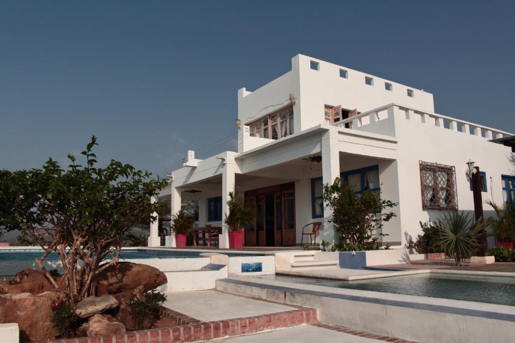 圣维罗尼卡Frente al Mar的一座白色的房子,前面设有一个游泳池