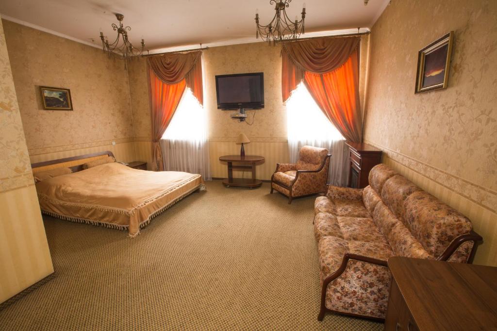 切尔诺夫策玛格纳特力士酒店的一间带沙发、床和电视的卧室