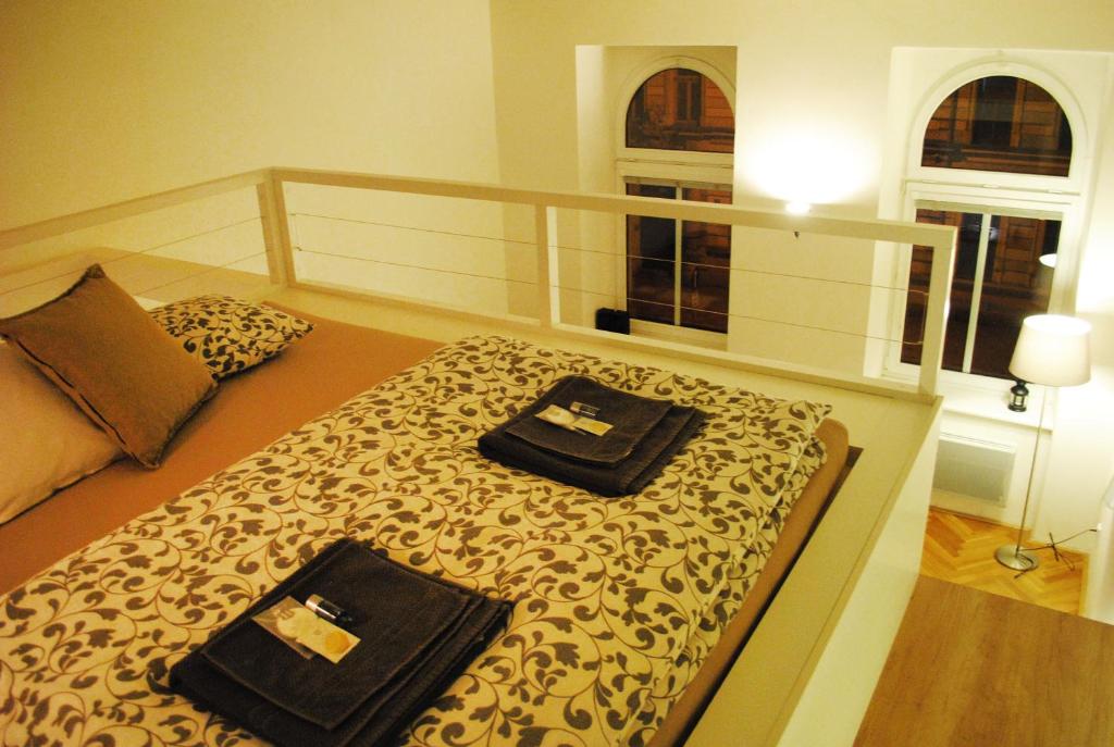 奥洛穆茨Apartments Centre in Style的一间卧室配有一张床,上面有两条毛巾