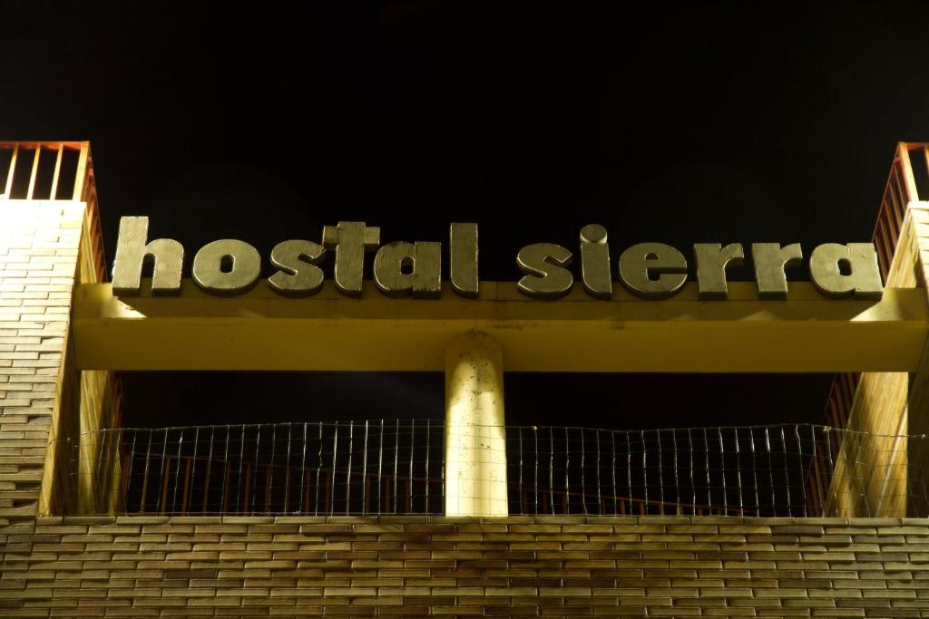 圣塞巴斯蒂安德洛斯雷耶斯塞拉利昂旅馆的夜间建筑物顶部的医院标志