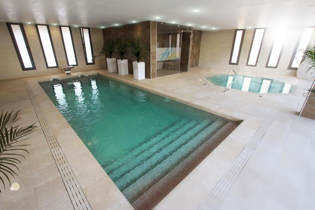 坎布里尔斯Apartamentos Cambrils Playa Spa的一个带游泳池的酒店客房内的大型游泳池