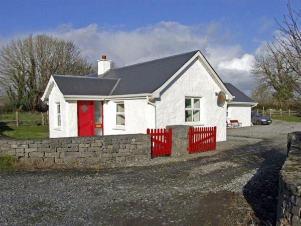 巴林罗布Delia's Cottage的车道上带红色围栏的白色房子