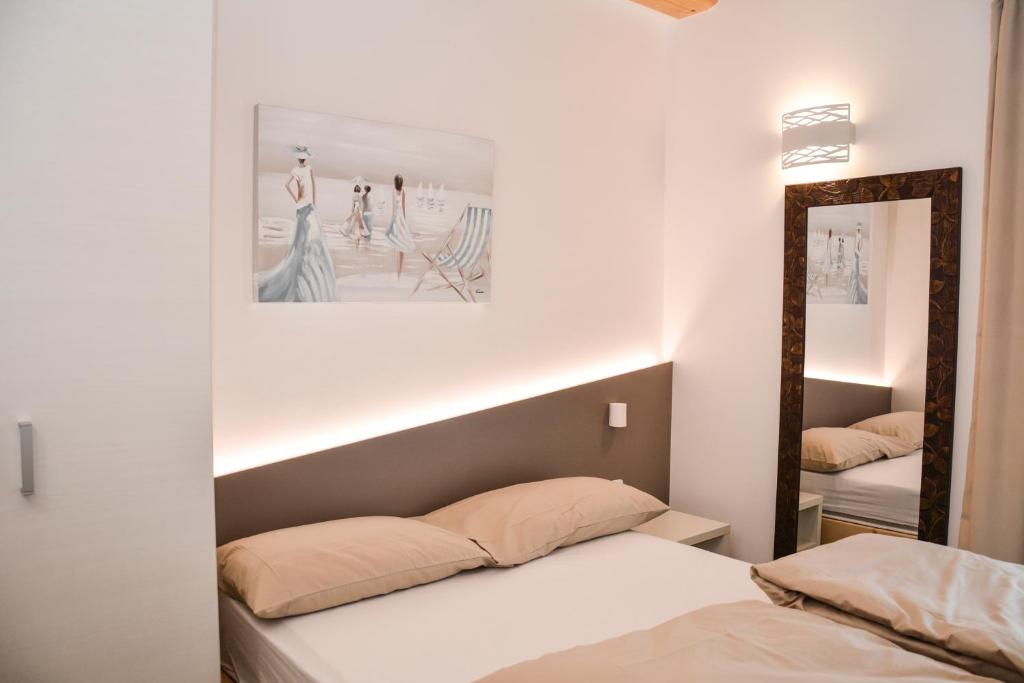 加尔达湖滨Theresia的一间卧室配有两张床和镜子