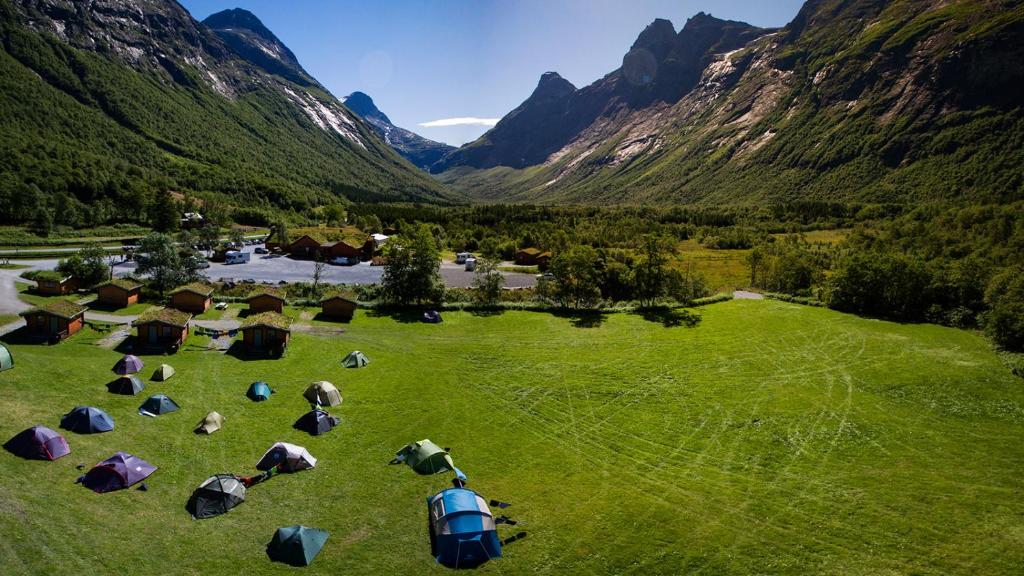 翁达尔斯内斯Trollstigen Camping and Gjestegård的享有带帐篷和山脉的田野的空中景致