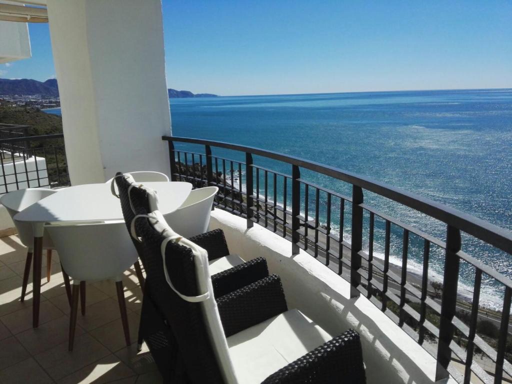 托罗克斯科斯塔Apartamento Lujo Calaceite的一个带桌椅的海景阳台
