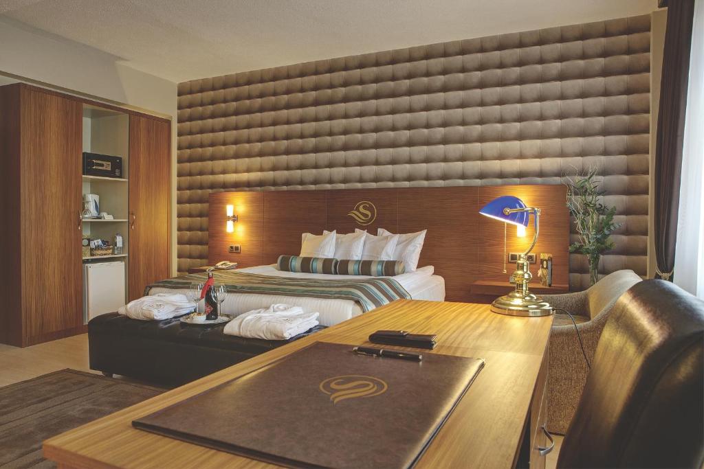 伊兹密尔苏苏鲁亚特兰蒂斯酒店的配有一张床和一张书桌的酒店客房