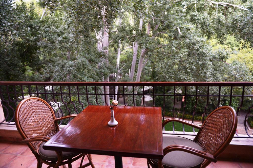 Chtaura马萨布基酒店的门廊上的木桌和椅子,享有美景