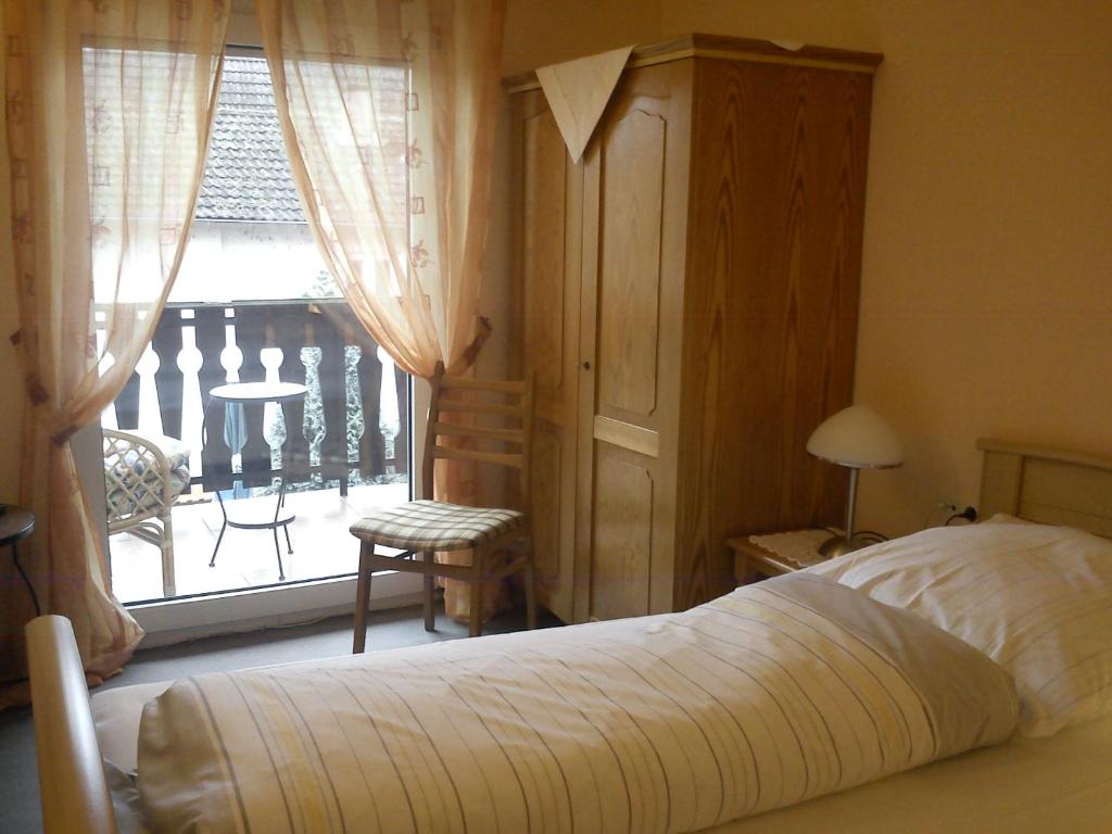 尼尔斯泰因楚库弗尔申科酒店的一间卧室设有一张床和一个阳台的窗户。