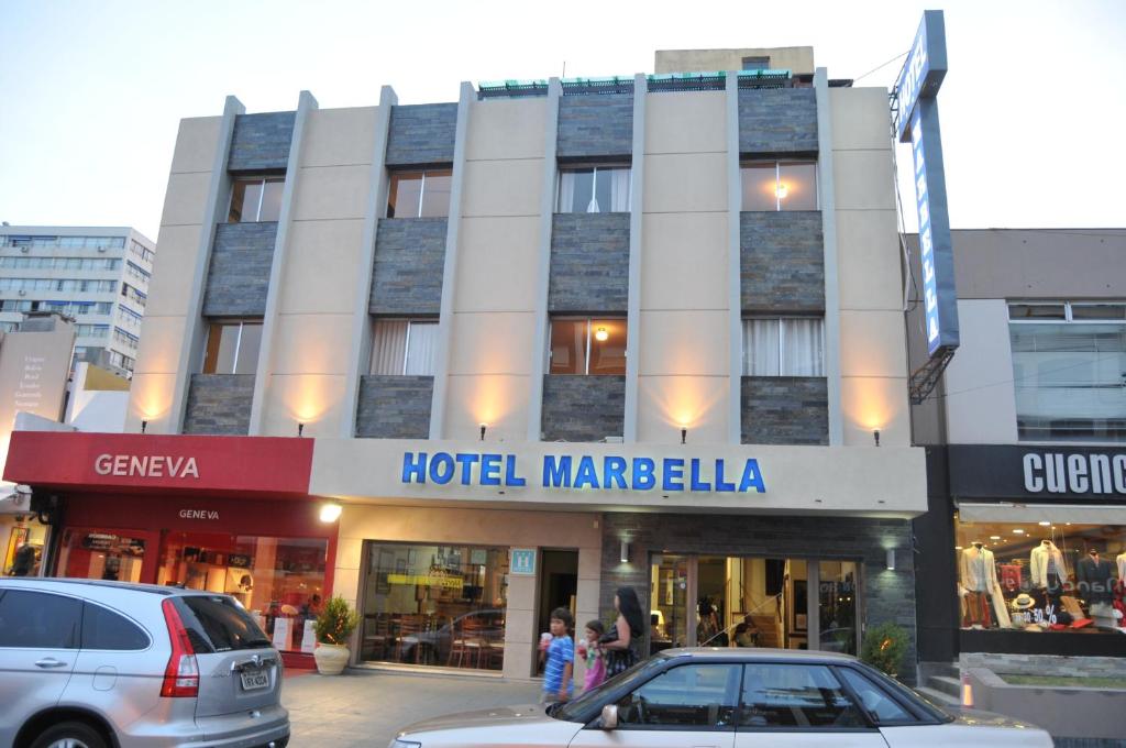 埃斯特角城马贝拉酒店的麦杰尔凯拉在城市里的一家酒店,门前有汽车停放