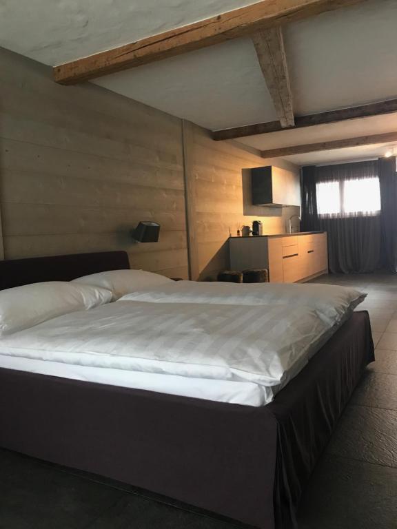 格施塔德Charly Studio In Gstaad的一间卧室配有一张带白色床单的大床