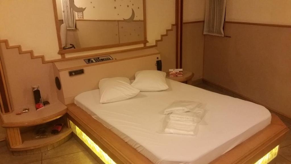 Vila AnastácioAmerica Motel (ADULT ONLY)的小房间设有床和镜子