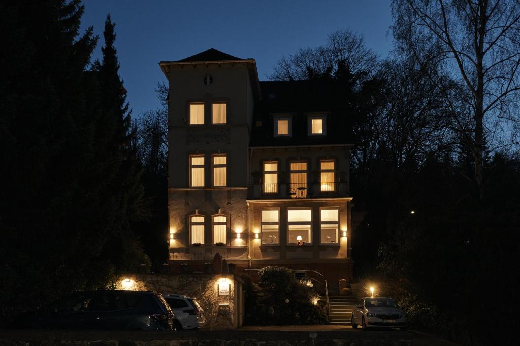 卡塞尔Hotel Burgfeld的一座大房子,晚上有灯