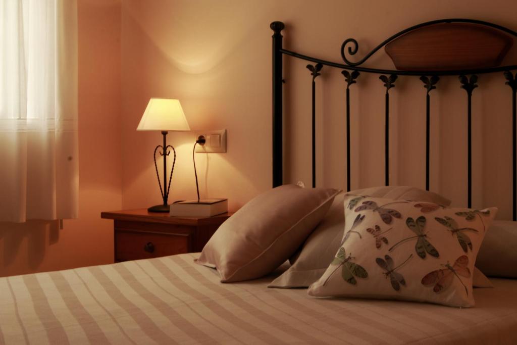 奥亚Casa Toñi的一间卧室配有带枕头和台灯的床