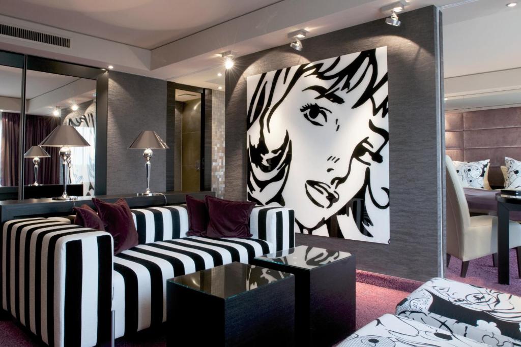 美因茨美因茨中庭酒店的客厅配有沙发和一幅女人画