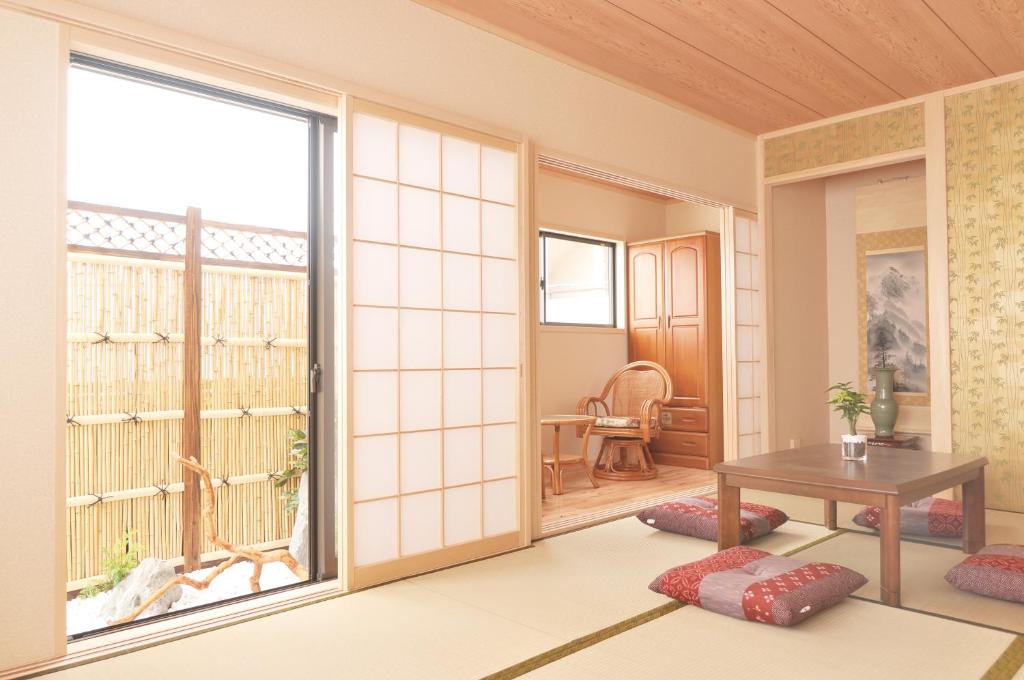 大阪Shirakabanoyado - Osakajo的客厅设有桌子和大窗户