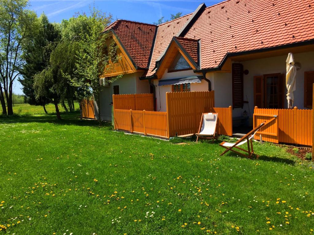 摩拉瓦托普利采Apartment Marjetica的一座带橙色围栏和草坪的房子