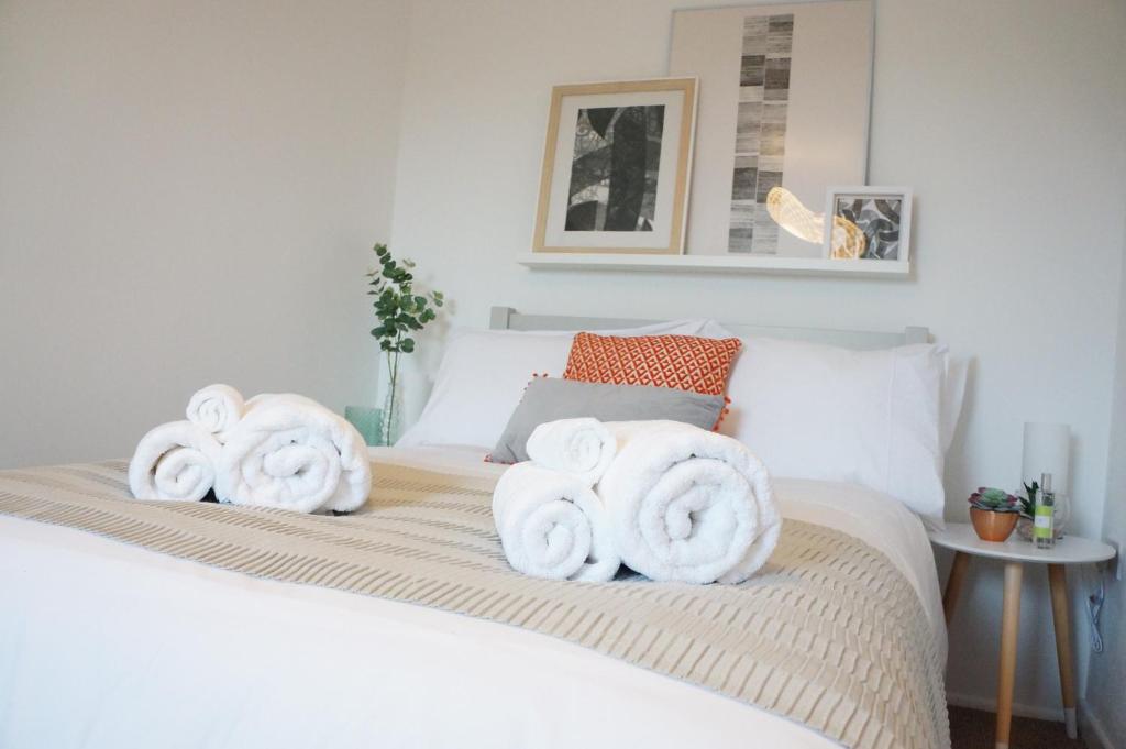 米尔顿凯恩斯The Oldbrook Apartment的床上铺有白色毛巾的床