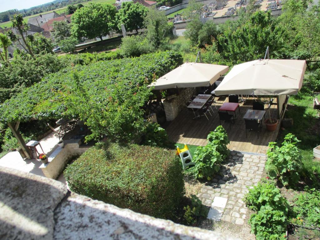 CrouzillesAuberge "AU BON ACCUEIL"的享有带遮阳伞和植物的露台的顶部景致