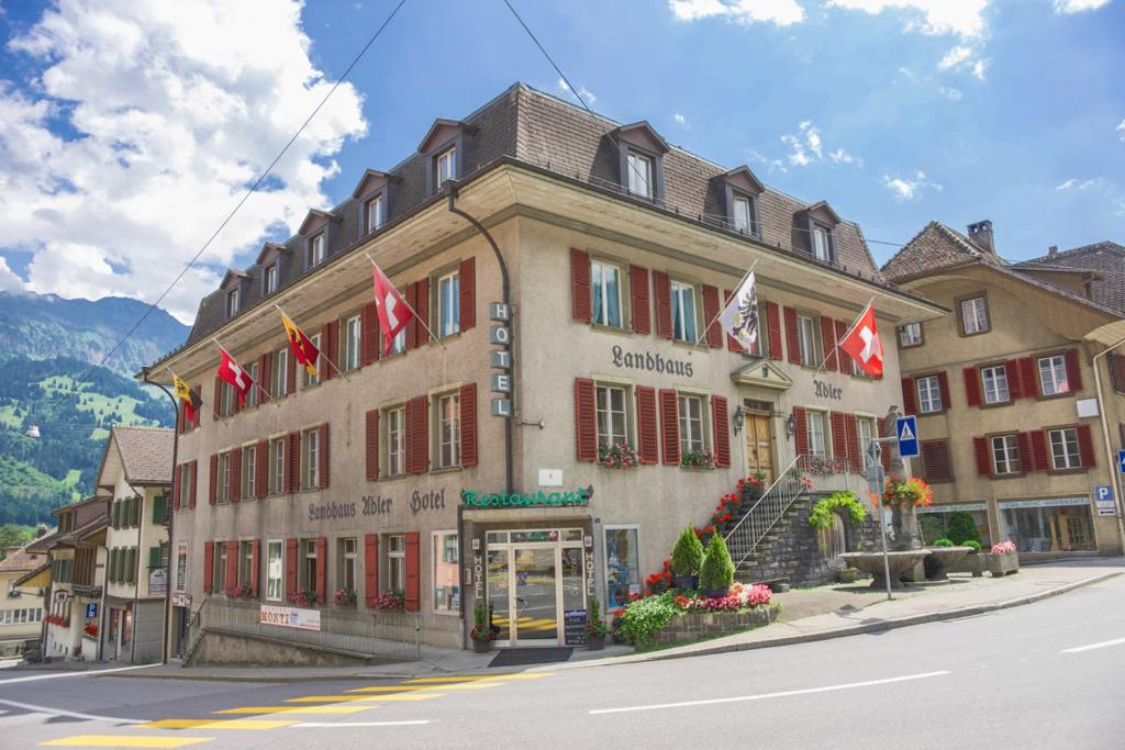 弗鲁蒂根Hotel Landhaus Adler的街道上悬挂着旗帜的建筑