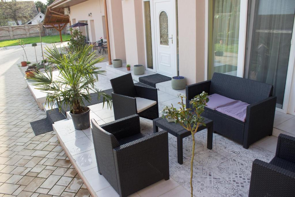 毛科Makotel Apartmanház的庭院配有桌椅和盆栽植物