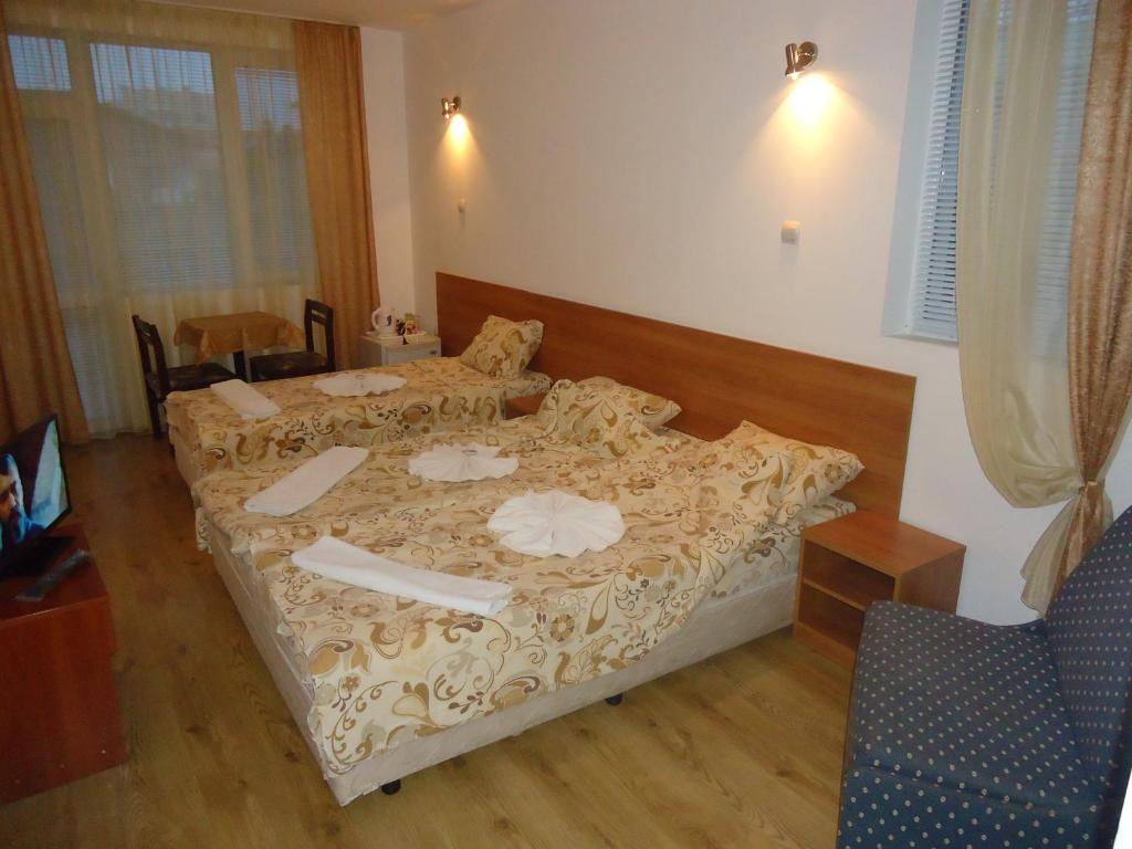 布尔加斯Matev Hotel的一间卧室配有两张带白色餐巾的床。