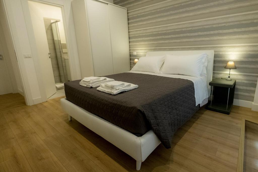 罗马Suite Pinturicchio的一间卧室配有一张床,上面有两条毛巾