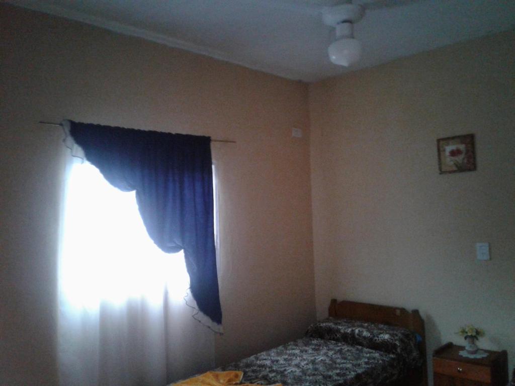 特尔马斯德里奥翁多Residencial Guadalupe的一间卧室配有床和蓝色窗帘