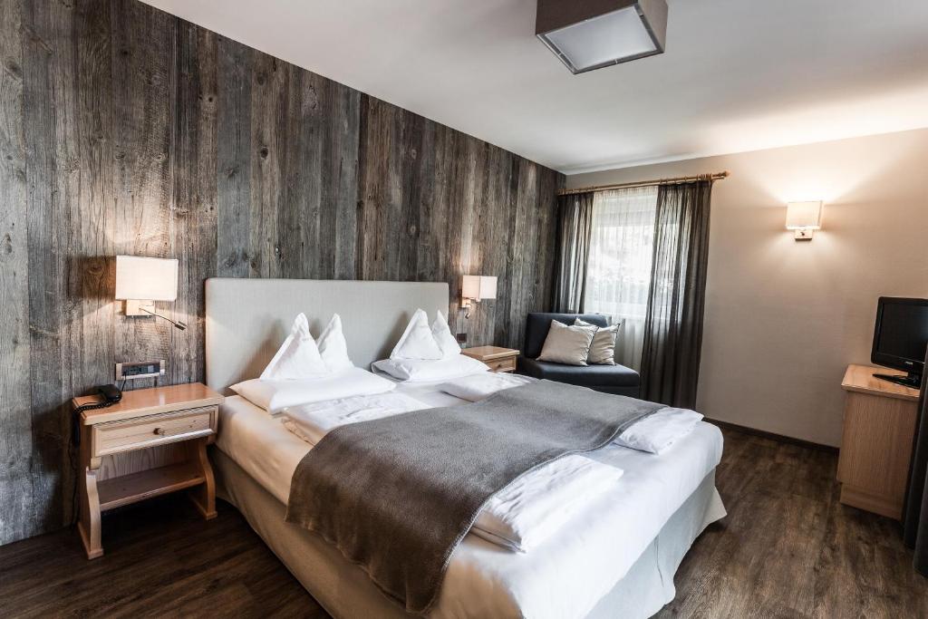 奥蒂塞伊加尼别墅公园酒店的酒店客房设有一张大床和一台电视。