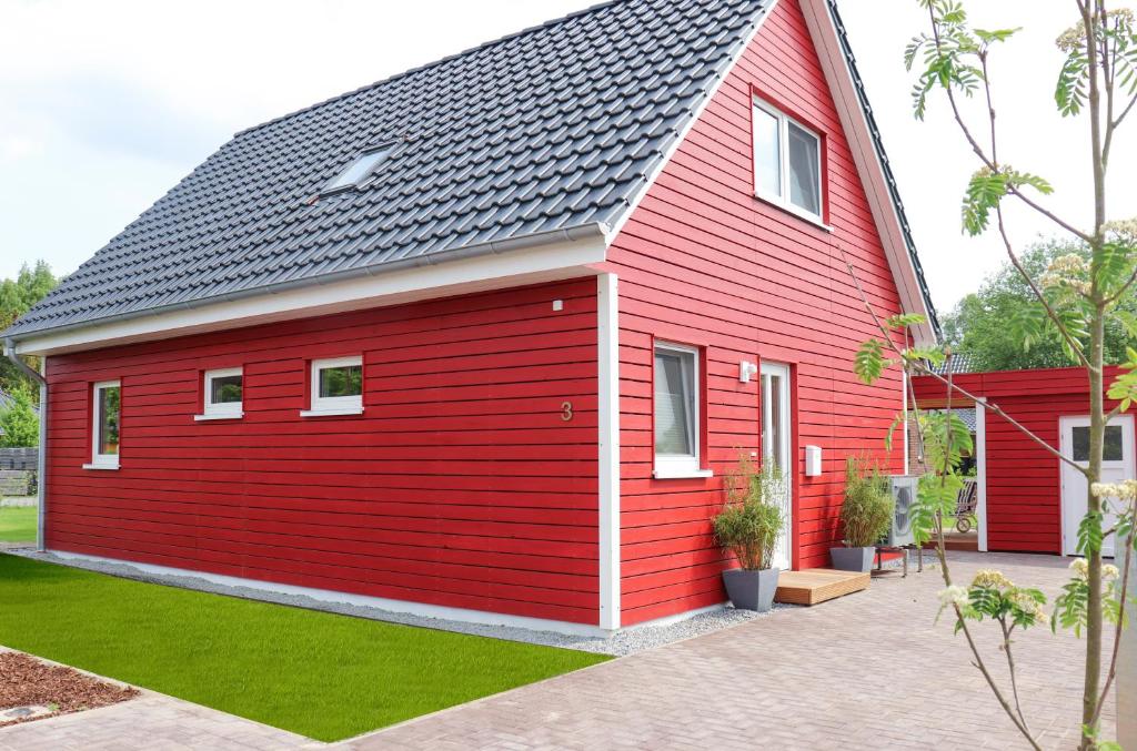 RiesteFerienhaus am Alfsee的黑色屋顶的红色房子