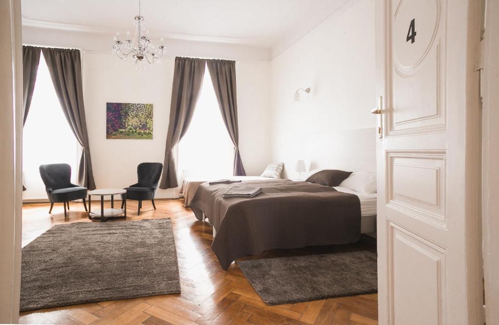 布达佩斯Ozone Private Rooms的一间卧室配有一张床、两把椅子和一张桌子