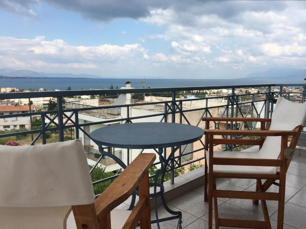 哈尔基斯Chalkida Beautiful Home with Stunning Views的海景阳台上的桌椅