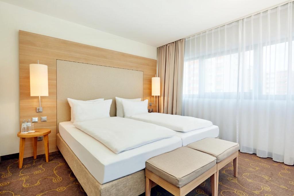 萨尔茨堡H+萨尔茨堡酒店 的酒店客房设有两张床和窗户。