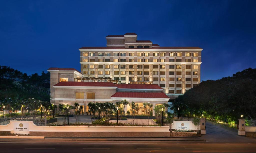 哥印拜陀哥印拜陀塔酒店的一座棕榈树环绕的大建筑