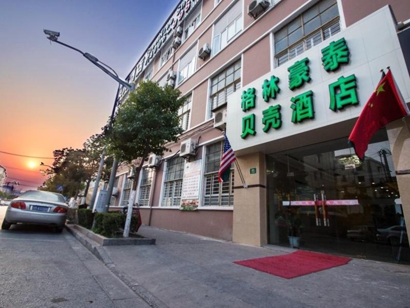 上海格林豪泰上海市浦东新区杨思地铁站杨新路贝壳酒店的前面有标志的建筑