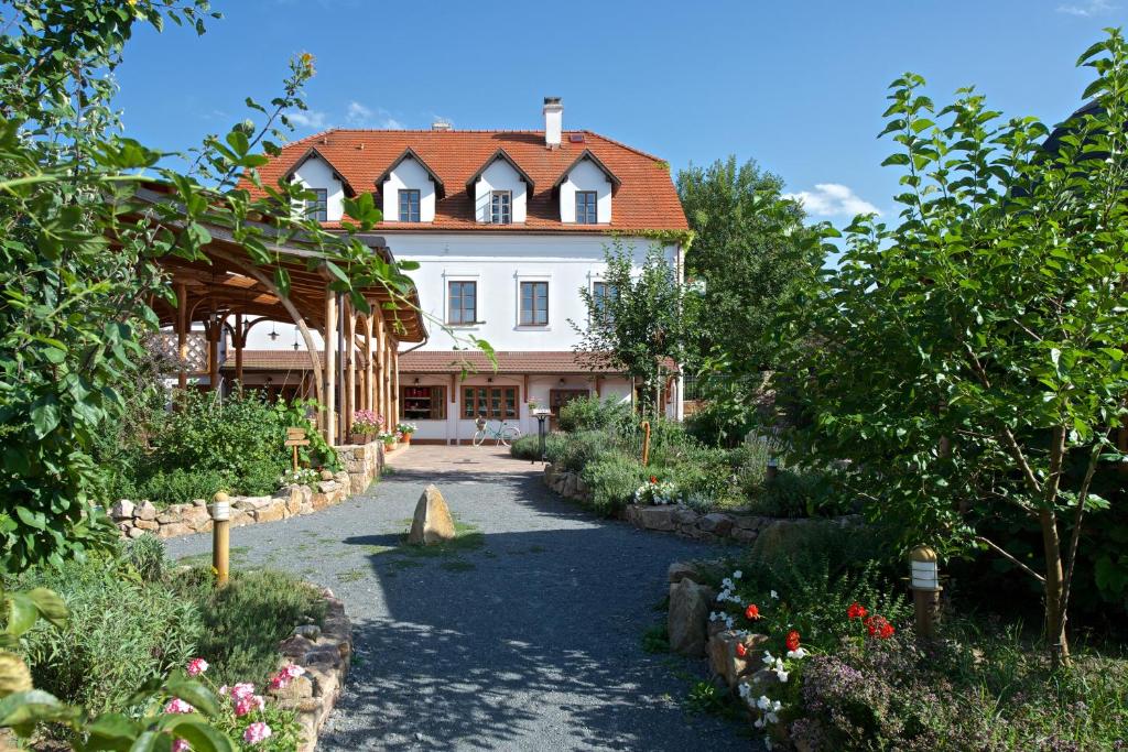 普鲁洪尼斯奶奶的花园旅馆及餐厅的一座白色的大房子,花园中设有一条小径