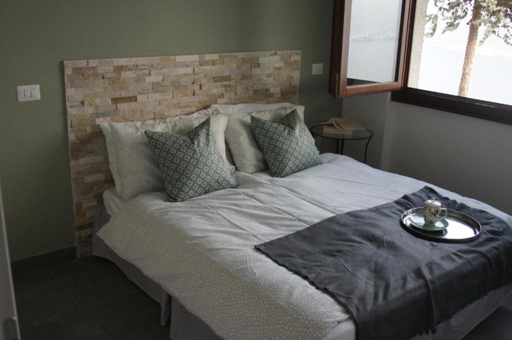 特雷莫西内casa dei nonni 2的一间卧室设有一张带砖墙的大床