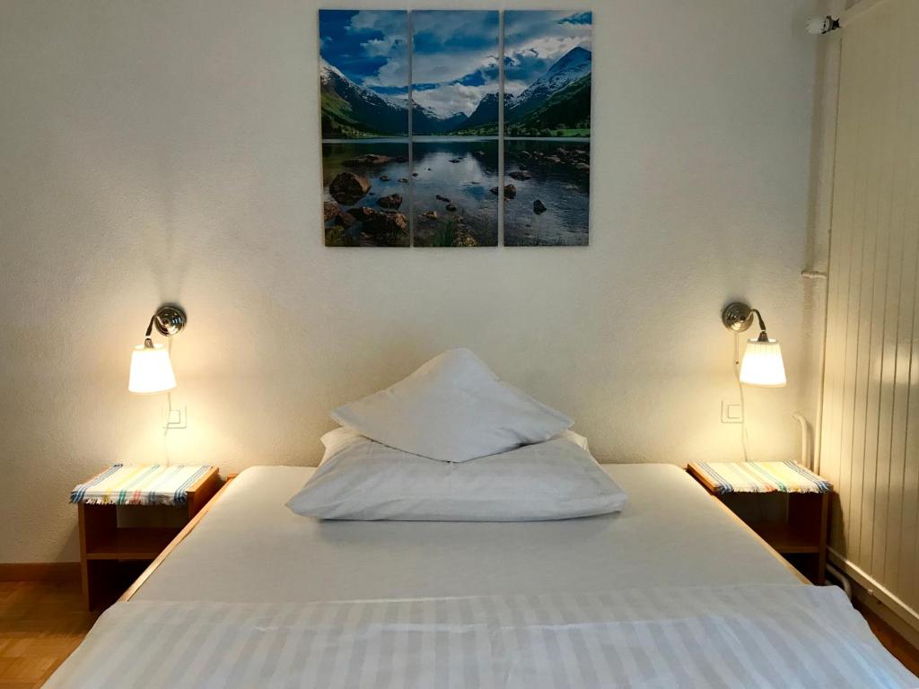 施伦贝格克朗宾馆的一间卧室配有白色床和两盏灯