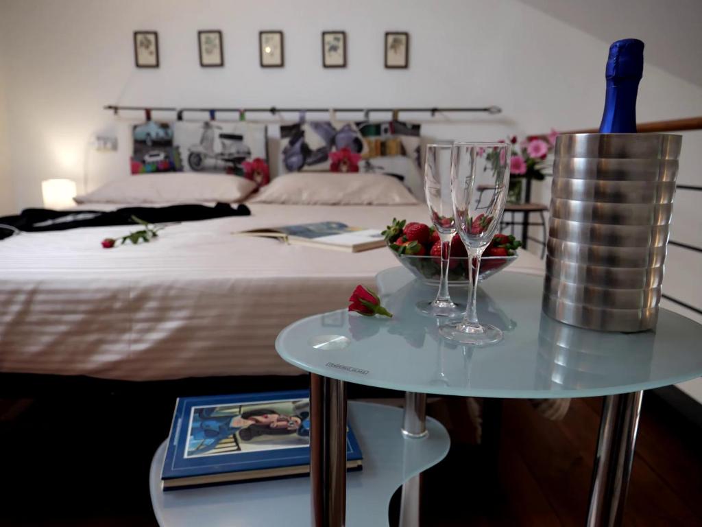 维泰博The Iris Flower的一间卧室配有一张床和一张桌子及一碗水果