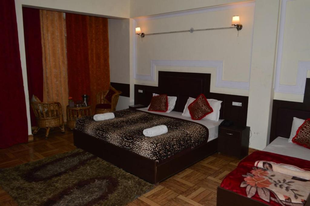 乔斯希马特Hotel Auli D的一间卧室配有一张带红色枕头的床