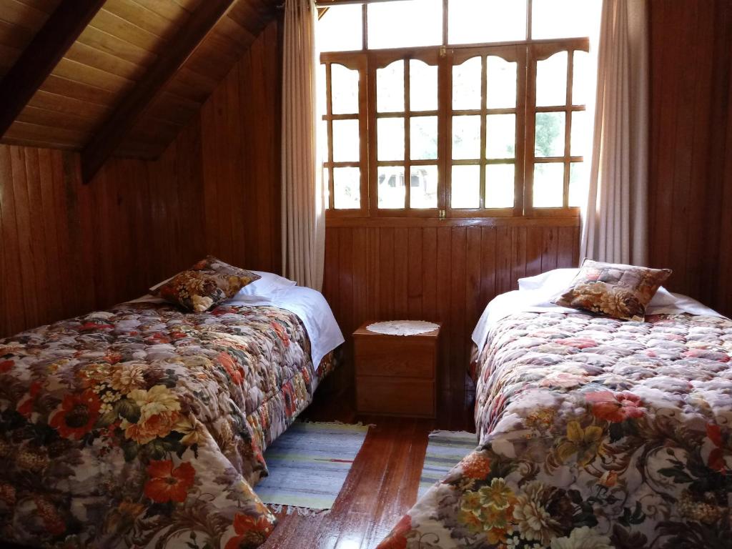 奥克萨潘帕La Cabaña de Noa的一间卧室设有两张床和窗户。