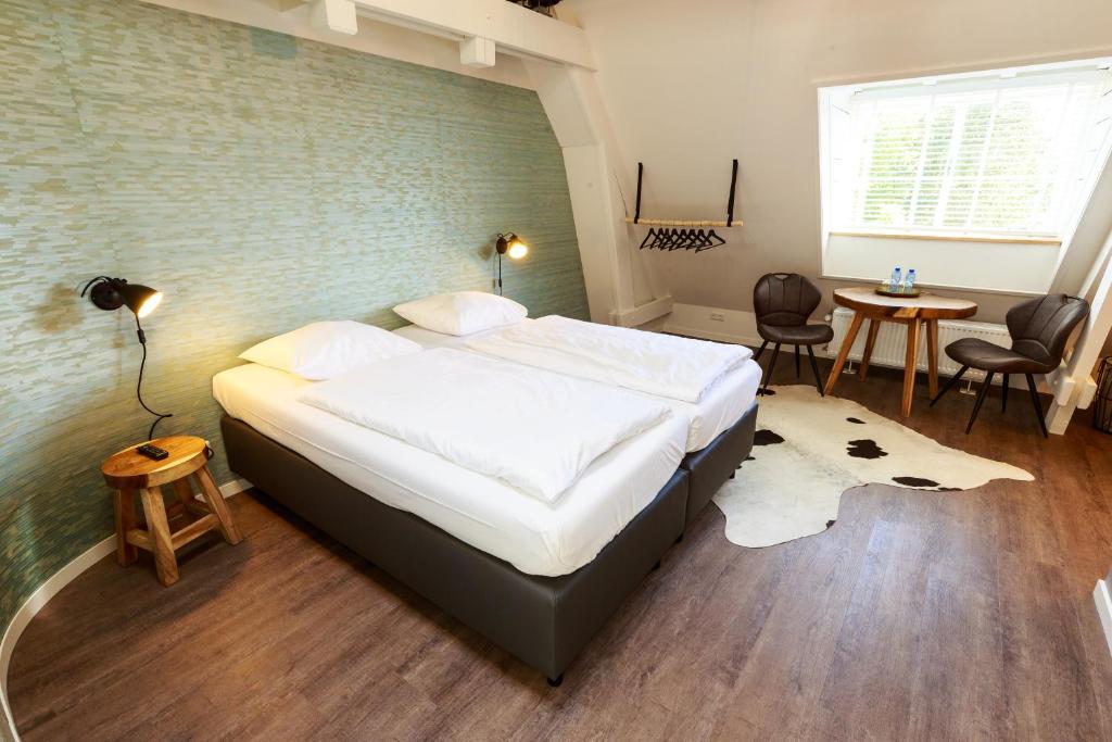 埃因霍温德格罗特比克住宿加早餐旅馆的一间卧室设有一张带砖墙的大床
