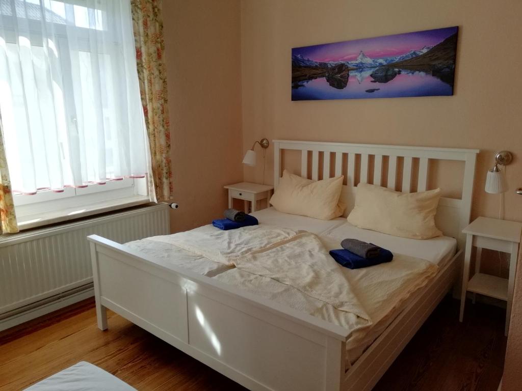 吕本瑙Ferienwohnung am Torbogen Nr.2的卧室配有白色的床和2个枕头