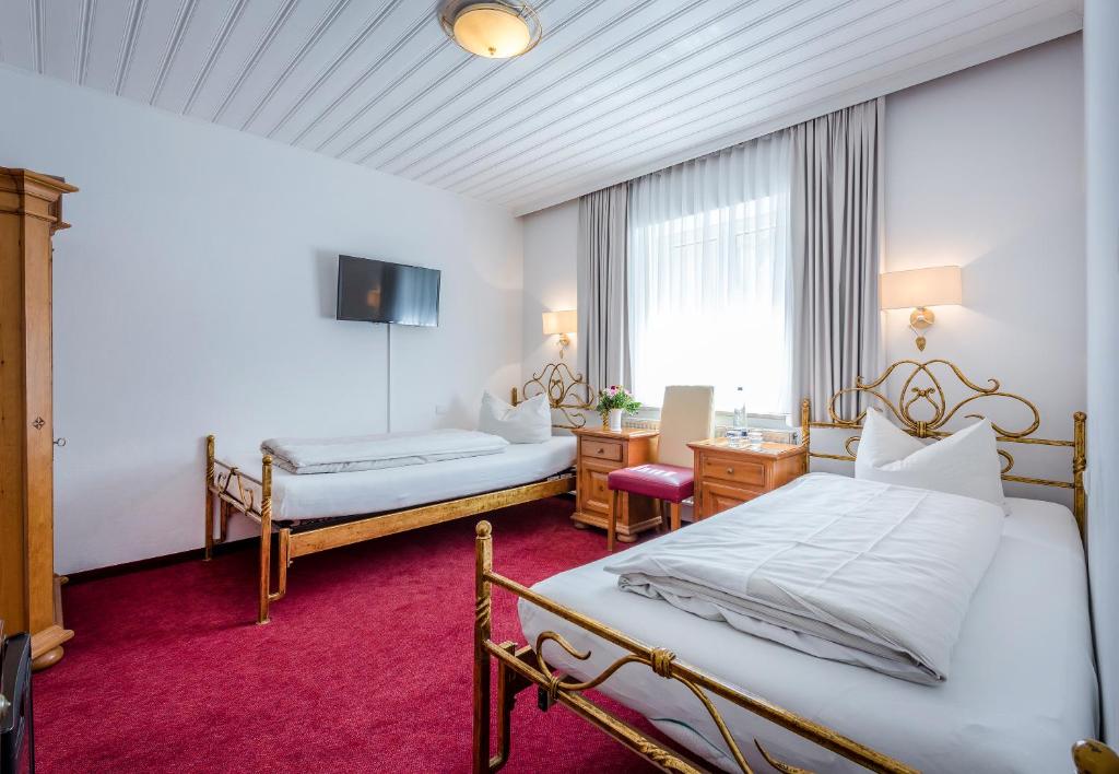 宁芬堡斯加罗斯兰蒙酒店客房内的一张或多张床位