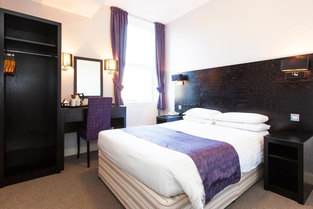布雷得佛修道院住宿酒店的酒店客房设有一张大床和一张书桌。