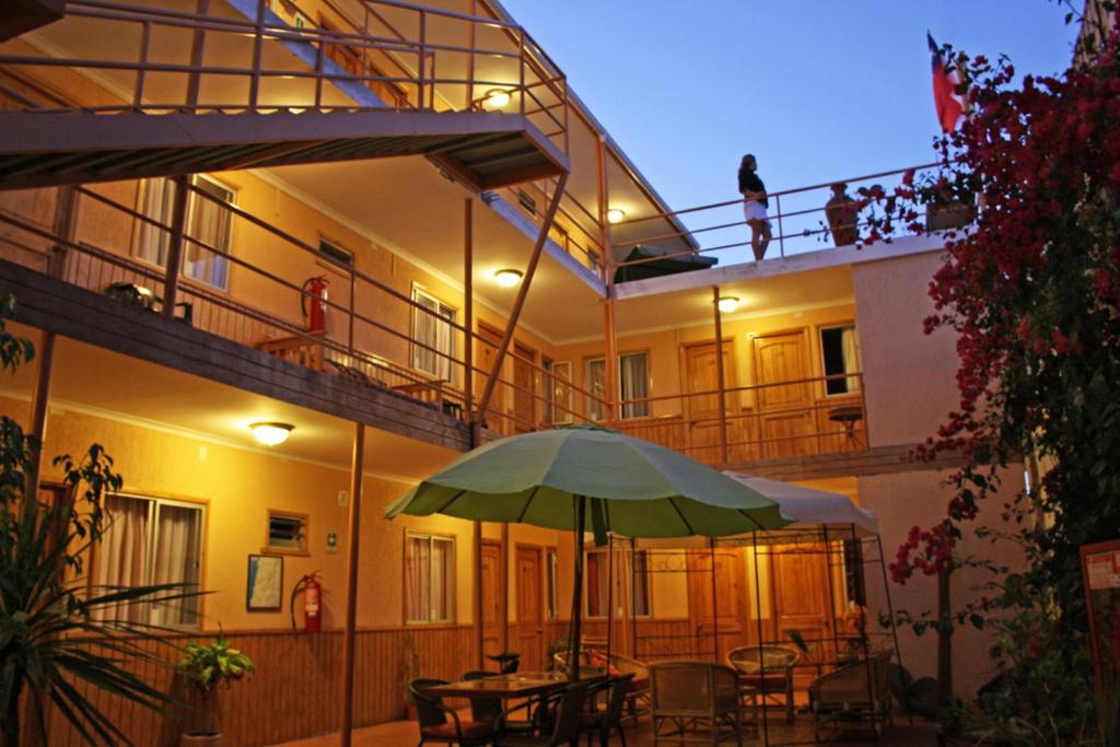 卡尔德拉Hotel CostaFósil的一座带绿伞露台的建筑