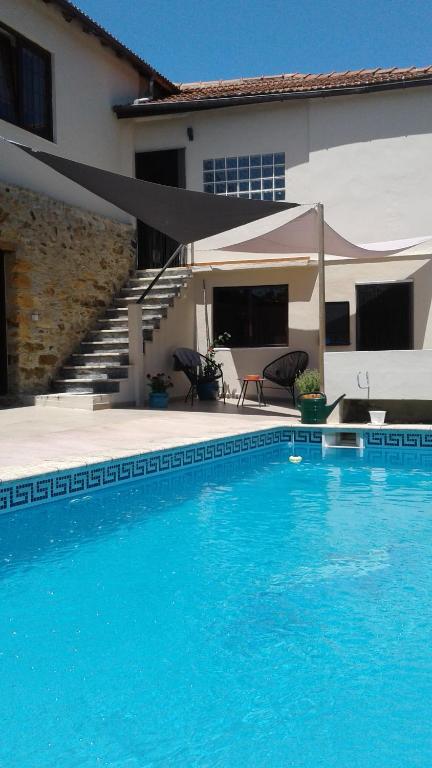 波亚里什新镇Casa de Coco的房屋前的大型游泳池